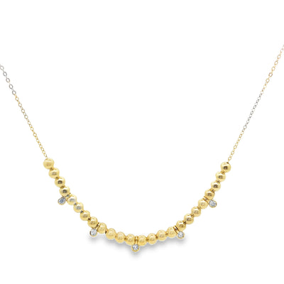 Gold beaded necklace on a white background