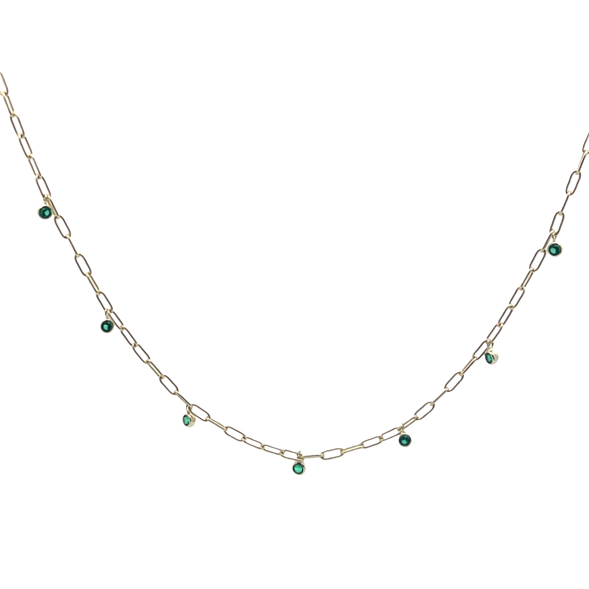 Gold chain necklace with green gemstones on a white background