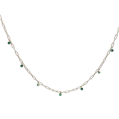 Gold chain necklace with green gemstones on a white background