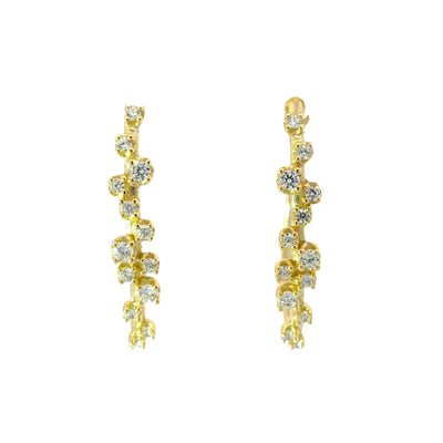 Gold earrings with clear gemstones on a white background