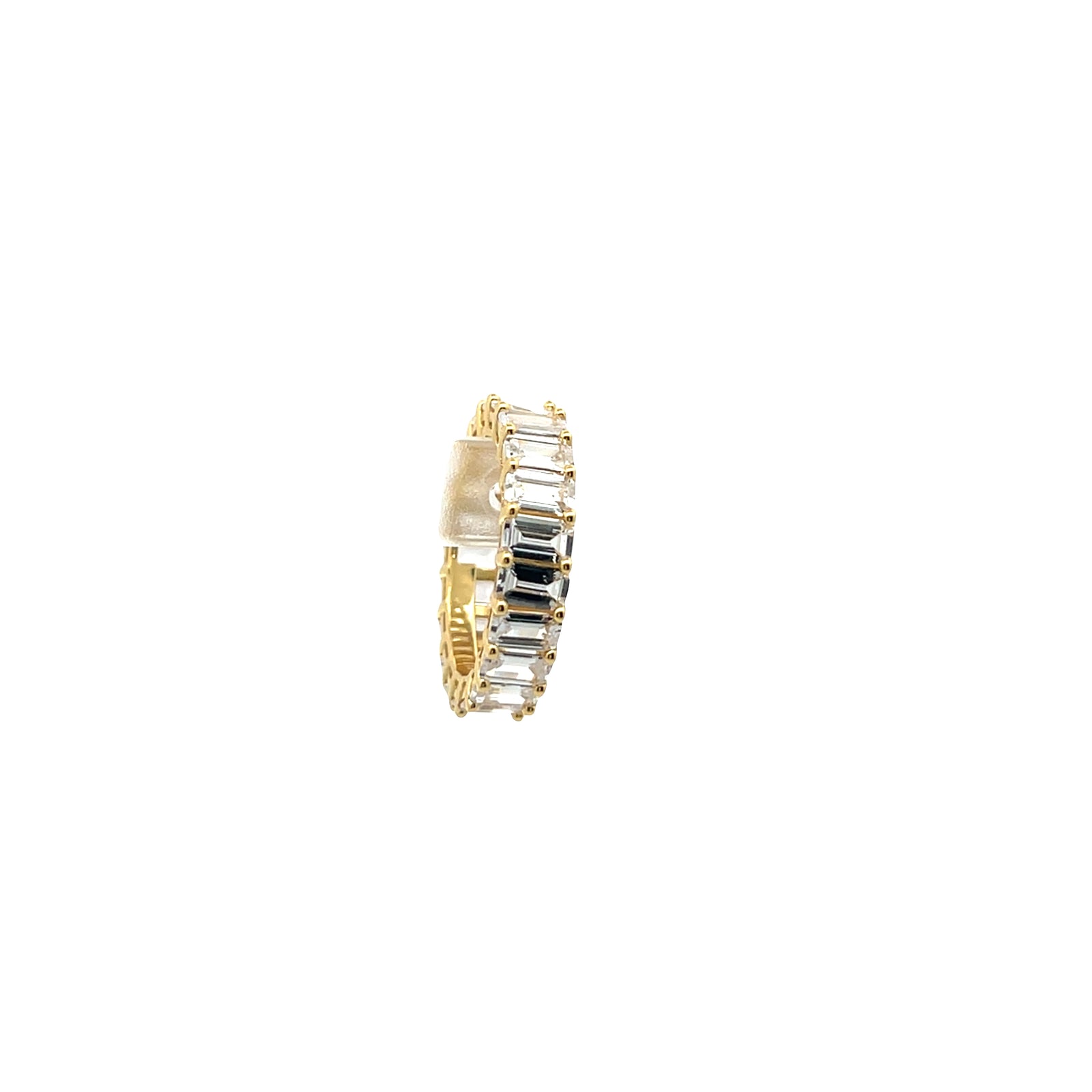 Gold ring with rectangular gemstones on a white background