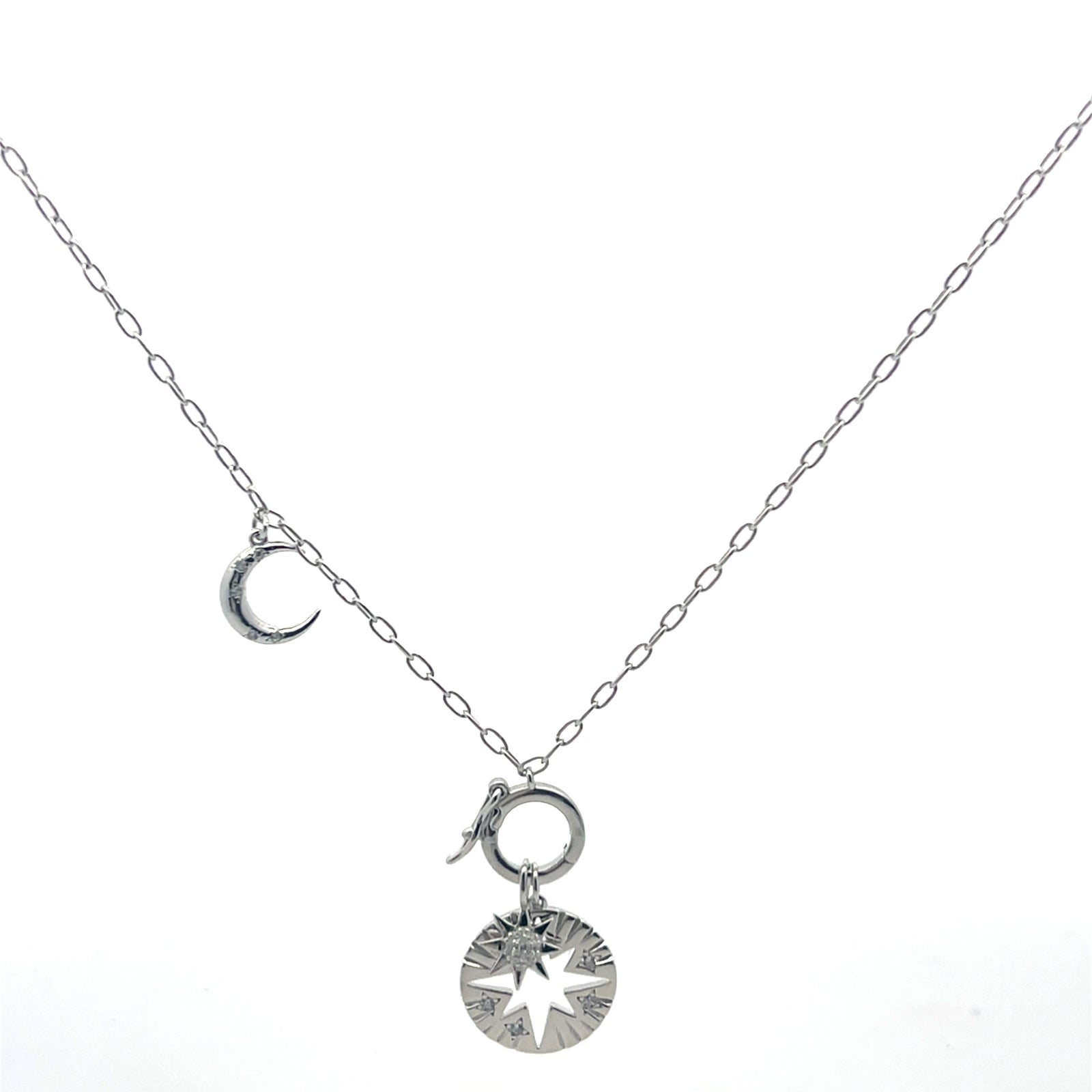 Silver necklace with moon and star pendants on a white background