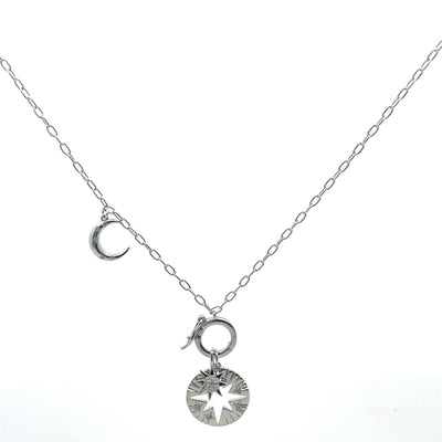 Silver necklace with moon and star pendants on a white background